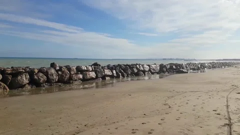 Stone breakwater on sandy seashore  Stock-Footage 168127229