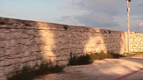 Stone brick wall exterior shot from moving driving vehicle Stock Footage 252153189