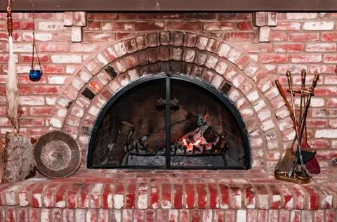 Stone bricks fireplace with glowing fire. Vintage style fireplace Stock Photos