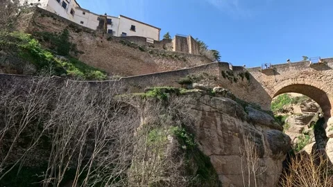 Stone Bridge and Cliffside Buildings in Ronda Gorge, Spain Stock Footage 339773543