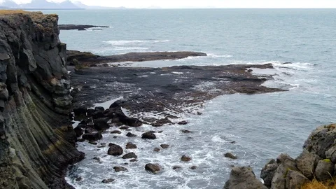 Stone Bridge cliff black beach in Arnarstapi iceland Stock Footage 100765859