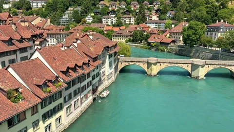 Stone bridge crosses the turquoise Aare River through old Bern in clear daylight Stock Footage 345232874