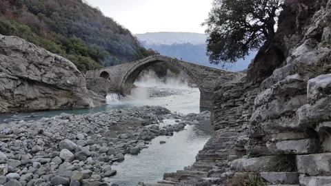 Stone bridge during sunset. Steam coming out of thermal baths Stock Footage 169884239