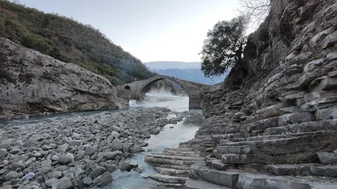 Stone bridge during sunset. Steam coming out of thermal baths Video stock 169884382