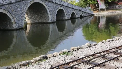 Stone bridge on the lake Stock Footage 141373936