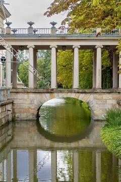 Stone bridge with many columns stands over a water canal where maintenance to Stock-Fotos
