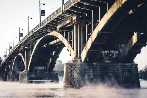 The stone bridge on the misty River Stock Photos