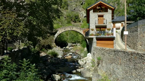 Stone bridge in a mountain river on the mountains of Pyrenees of Catalonia. Video stock 170567392