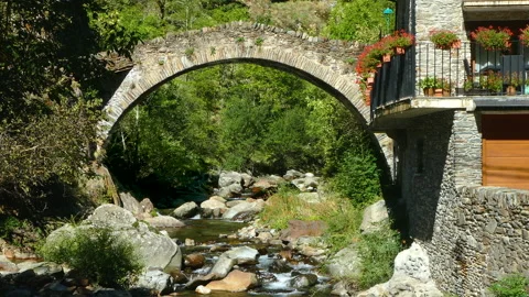 Stone bridge in a mountain river on the mountains of Pyrenees of Catalonia. Stock Footage 170567468