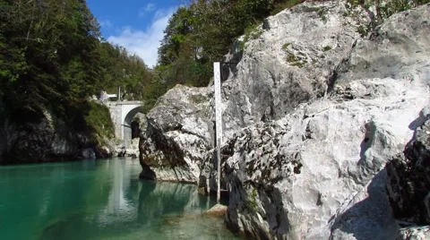 Stone bridge over an emerald river Stock Footage 42529809