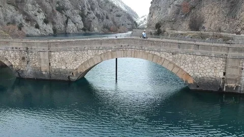 Stone bridge over a winter river Stock Footage 114749020
