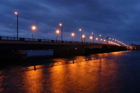 Stone bridge in Riga at night with burning lanterns Stock Photos