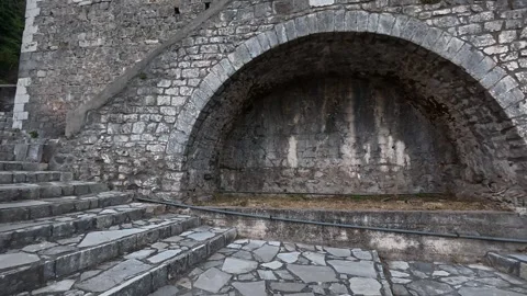 Stone bridge with steps leading to public building in mountain village Video stock 327392371