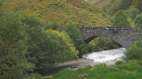 Stone Bridge in a Valley and Small River in Scotland Video stock 85242497