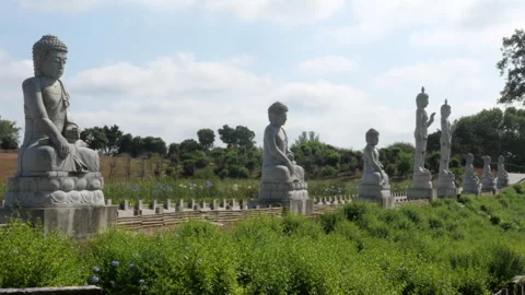 Stone Buddha Statues in Lush Garden, Eden Garden Portugal Spiritual Land 動画素材 336959751