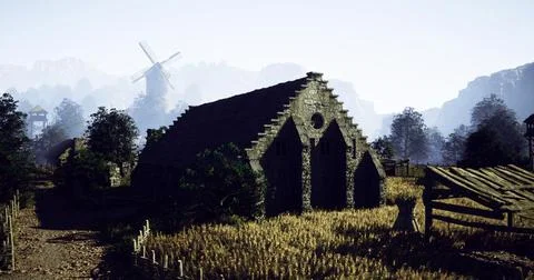Stone building amid wheat fields and distant windmill in countryside Ilustración de archivo