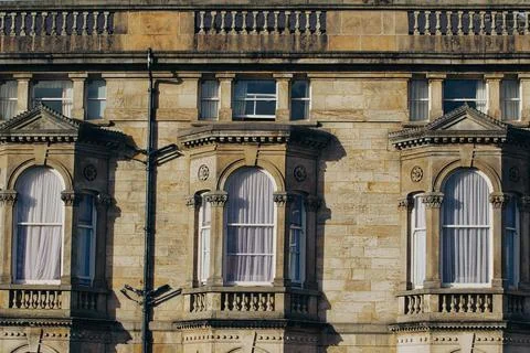 Stone Building Facade with Three Arch Bay Windows 스톡 사진