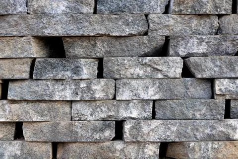 Stone butts wall surface texture. Brickwork masonry background. Stock Photos