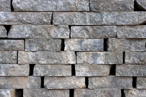 Stone butts wall surface texture. Brickwork masonry background. Stock Photos