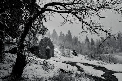 Stone cabin in the winter forest Stock Photos