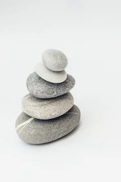 Stone cairn on light background. Stock Photos