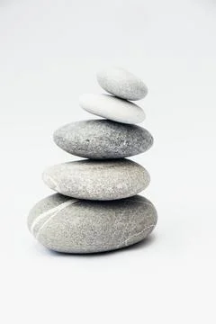 Stone cairn on light background. Stock Photos
