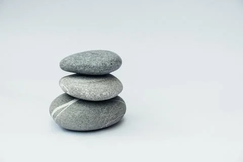 Stone cairn on light background. Stock Photos