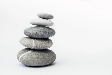 Stone cairn on light background. Stock Photos