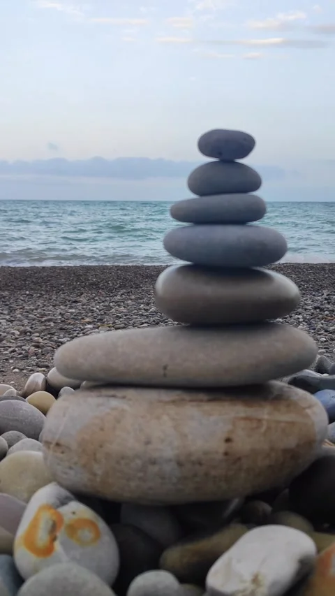 Stone Cairn with Morning Waves in the Background Stock Footage 309468293