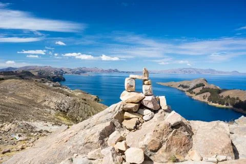 Stone cairn with scenic dramatic landscape on Island of the Sun, Titicaca Lak Stock Photos