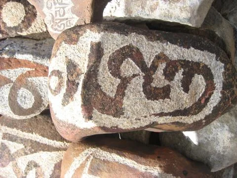 Stone carved with symbols of prosperity Stock Photos