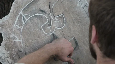 Stone carving process. Stone sculptor or stonecutter creates pattern on the Stock Footage 119277597