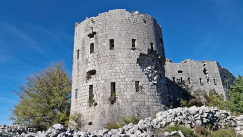 Stone castle - derelict round tower of a fortress on a sunny day, under clear Stock Footage 232716481
