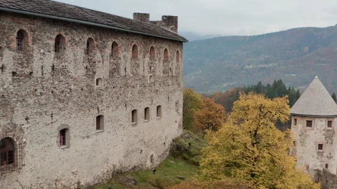 Stone castle facade with arched windows and tower in Pergine Valsugana Stock-Footage 325872833