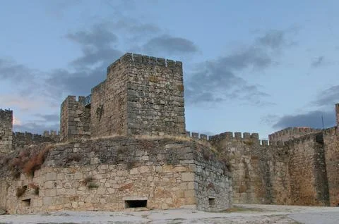 Stone castle ruins with cloudy background, dry ground visible Stock Photos