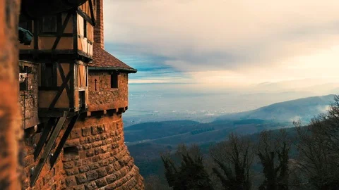 Stone castle viewpoint at a beautiful sunset of clouds and orange sunrays Stock Footage 124483203