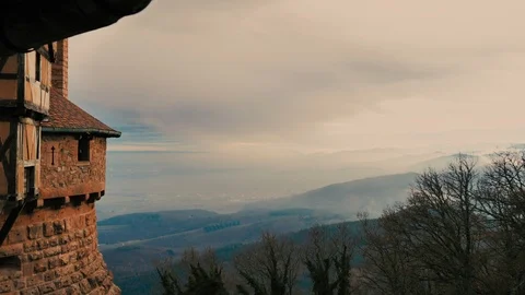 Stone castle viewpoint at a beautiful sunset of clouds and orange sunrays plane Stock Footage 124483642
