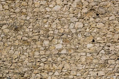 Stone castle wall background from limestone segments Stock Photos