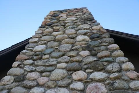 Stone Chimney on Rustic Cabin Against Open Sky Stock Photos