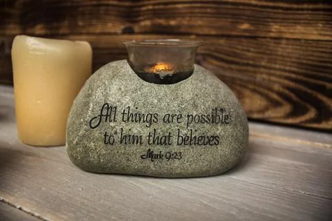 Stone with christian scripture with light candle Stock-Fotos