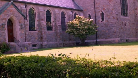 Stone Church With Gothic Arch Windows And Stained Glass Vídeo Stock 76901891