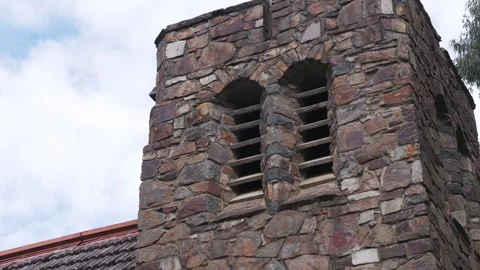 Stone church tower against a cloudy sky Stock Footage 341903224