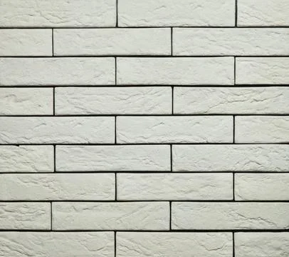 Stone cladding wall made of striped stacked slabs of white and grey rocks. .. Stock Photos