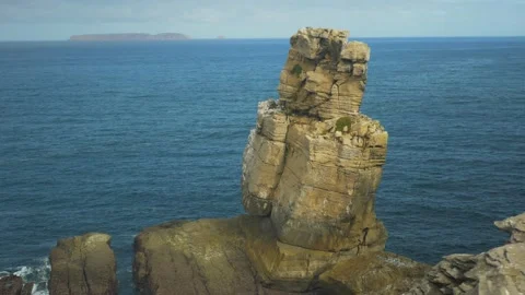 Stone cliffs on the coast with the ocean Stock Footage 169415633