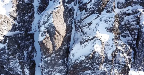 Stone cliffs covered with snow. Epic footage of mountains. Extreme rocks. Stock Footage 100706549