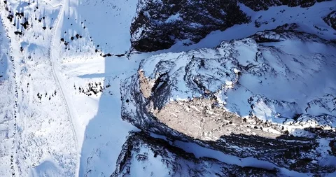 Stone cliffs covered with snow. Epic footage of mountains. Extreme rocks. Stock Footage 100707493