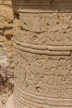 Stone column with ancient inscriptions at the Apollo Hylates Sanctuary in Cyp Stock Photos