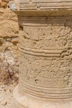 Stone column with ancient inscriptions at the Apollo Hylates Sanctuary in Cyp Stock Photos