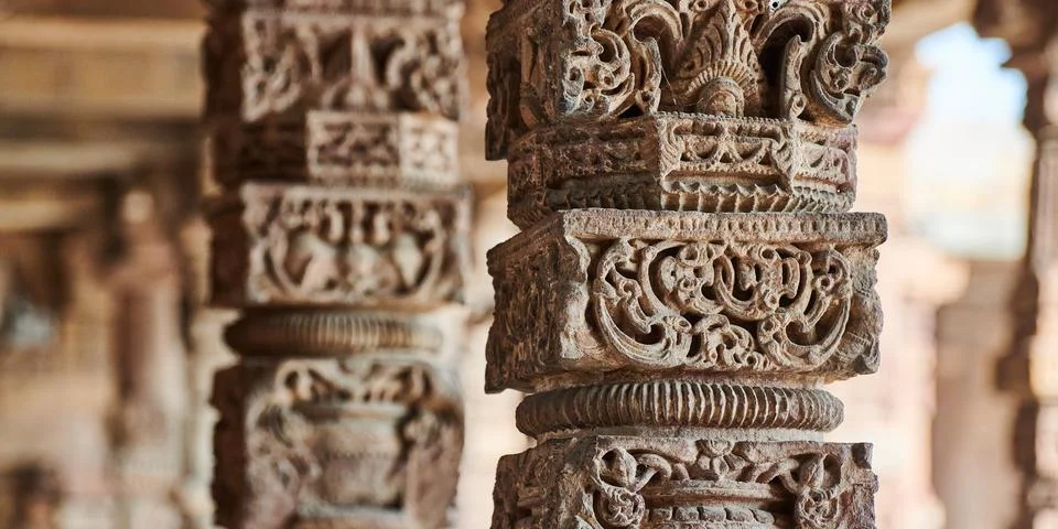 Stone columns with decorative bas relief of Qutb complex in South Delhi, In.. Stock Photos