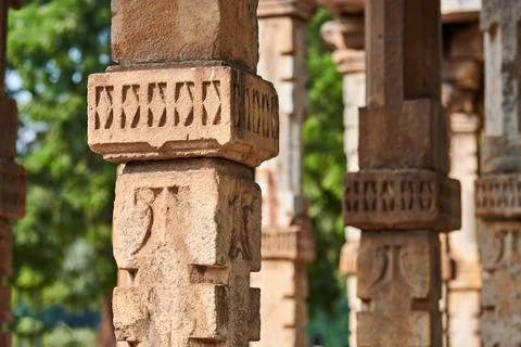 Stone columns with decorative bas relief of Qutb complex in South Delhi, In.. Stock Photos